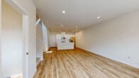 Located at 19122 E 62nd Ave in Denver, CO, this well-designed two-story home offers 3 bedrooms and 3 bathrooms across two thoughtfully laid-out floors. The main level features an open-concept living room and kitchen area finished with light hardwood-style flooring and recessed lighting throughout. The kitchen is equipped with white shaker cabinetry, white quartz countertops, a subway tile backsplash, stainless steel appliances including a range, microwave, and refrigerator, and a central island that provides additional workspace and storage. A half bathroom on the main floor includes a wall-mounted pedestal sink, mirror, and wood-look tile flooring. A staircase connects the main level to the upper floor, where all three bedrooms are located. The spacious primary bedroom features plush carpeting, a ceiling fan, and multiple windows that invite natural light and neighborhood views. The additional bedrooms are also carpeted and well-lit with large windows. The upper-level full bathrooms are finished with white cabinetry, quartz countertops, subway-tiled tub-shower combinations, and wood-look flooring. A dedicated laundry room with side-by-side washer and dryer adds everyday convenience to this clean, modern home.