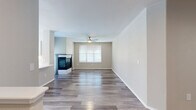 Located at 1855 Denver West Ct in Lakewood, Colorado, this well-appointed 2-bedroom, 2-bathroom home offers a thoughtfully designed layout across a single level, accessed via a carpeted staircase. The open living area is a standout feature, showcasing wood-look plank flooring, a ceiling fan, and a corner fireplace that adds warmth and character to the space. Natural light filters in through white-slatted blinds, creating a bright and welcoming atmosphere throughout.

The kitchen is a functional highlight, featuring white upper cabinetry, gray lower cabinets, quartz countertops, a subway tile backsplash, and a full suite of stainless steel appliances including a refrigerator, electric range, microwave, and dishwasher. A window above the sink brings in additional natural light.

Both bedrooms are generously sized, finished with plush carpeting and ceiling fans, and each receives natural light through well-placed windows. Three closets provide ample storage throughout the home. The two bathrooms are clean and modern, each offering a tub/shower combination, white vanity cabinetry, and wood-look tile flooring. A hallway connects the private areas of the home, completing a practical and comfortable floor plan.