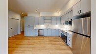 Located in Liberty Lake, WA, this thoughtfully designed 3-bedroom, 2-bathroom residence offers a clean, modern aesthetic throughout its single-floor layout. Light-toned hardwood flooring flows seamlessly across every room, creating a bright and cohesive feel.

The kitchen is a standout feature, equipped with sleek gray flat-front cabinetry, white quartz countertops, stainless steel appliances including a gas range, built-in microwave, and dishwasher, along with recessed lighting that enhances the contemporary look.

Each bedroom is finished with the same warm hardwood floors and features large windows dressed with horizontal blinds, allowing ample natural light and views of the surrounding greenery. Individual wall-mounted mini-split units in the bedrooms provide personalized climate control. The primary bedroom includes access to a dedicated closet with built-in wire shelving for organized storage.

The two bathrooms are clean and functional: one features a full soaking tub with shower, while the other offers a walk-in shower stall. Both include white quartz vanity tops, modern cabinetry with black hardware, and hardwood flooring. A utility room and additional closet space round out the practical amenities, making this a well-appointed and move-in-ready residence.