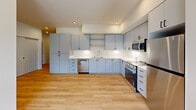 Located in Liberty Lake, WA, this thoughtfully designed 3-bedroom, 2-bathroom residence offers a clean, modern aesthetic throughout its single-floor layout. Light-toned hardwood flooring flows seamlessly across every room, creating a bright and cohesive feel.

The kitchen is a standout feature, equipped with sleek gray flat-front cabinetry, white quartz countertops, stainless steel appliances including a gas range, built-in microwave, and dishwasher, along with recessed lighting that enhances the contemporary look.

Each bedroom is finished with the same warm hardwood floors and features large windows dressed with horizontal blinds, allowing ample natural light and views of the surrounding greenery. Individual wall-mounted mini-split units in the bedrooms provide personalized climate control. The primary bedroom includes access to a dedicated closet with built-in wire shelving for organized storage.

The two bathrooms are clean and functional: one features a full soaking tub with shower, while the other offers a walk-in shower stall. Both include white quartz vanity tops, modern cabinetry with black hardware, and hardwood flooring. A utility room and additional closet space round out the practical amenities, making this a well-appointed and move-in-ready residence.