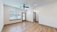 Located at 101 Dean Ave in Raymore, Missouri, this well-designed single-story home offers three bedrooms, two bathrooms, and a thoughtfully organized layout across one floor. Light wood-look luxury vinyl plank flooring flows seamlessly throughout every room, tying the modern aesthetic together.

The open-concept kitchen serves as a central hub of the home, featuring light wood cabinetry with black hardware, stainless steel appliances including a refrigerator, range, and microwave, a subway tile backsplash, neutral quartz-style countertops, and a kitchen island with a built-in sink — ideal for both cooking and casual dining.

The living room is bright and inviting, with large windows fitted with blinds that allow abundant natural light, recessed lighting, and a ceiling fan overhead. Bedrooms are generously sized, including a spacious primary bedroom with a ceiling fan and ample natural light. A dedicated walk-in closet with wrap-around shelving and hanging rods provides excellent storage.

The primary bathroom offers a glass-enclosed walk-in shower, a modern vanity with light wood cabinetry, and wood-look flooring. The second bathroom features a full tub-shower combo with matching contemporary finishes. Two hallways connect the rooms efficiently, completing this clean, move-in-ready home.