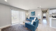 Located at 100 Wood Terrace Place in Atlanta, GA, this well-appointed 2-bedroom, 2-bathroom single-floor home offers a thoughtfully designed layout that maximizes comfort and functionality. The open-concept living, dining, and kitchen area forms the heart of the home. The living room is bright and welcoming, featuring large sliding glass doors dressed with vertical blinds that flood the space with natural light and provide outdoor views. Light wood-style flooring runs throughout the main living areas, lending a clean, modern aesthetic. The galley-style kitchen is efficiently laid out with white cabinetry, light stone countertops, a subway tile backsplash, stainless steel appliances, and pendant lighting — a practical and attractive space for cooking and entertaining. The adjacent dining area accommodates a full dining set beneath a stylish overhead light fixture. Both bedrooms are carpeted and generously proportioned, with ceiling fans and ample closet space — including a walk-in closet with built-in shelving and hanging rods. The two bathrooms feature light wood-style tile flooring and clean white vanities. A dedicated in-unit laundry room with full-size washer and dryer adds everyday convenience. With three closets total and a well-connected hallway layout, storage is plentiful throughout this inviting Atlanta home.