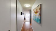 Located at 233 E Wacker Drive in Chicago's vibrant downtown, this one-bedroom, one-bathroom residence offers a well-organized single-floor layout. A welcoming hallway with warm hardwood flooring and a textured ceiling leads into the main living areas, providing a tasteful first impression.

The combined dining and living room serves as the heart of the home, bathed in natural light from large windows that frame striking city skyline views. The kitchen is well-appointed with warm wood cabinetry, dark granite countertops, and stainless steel appliances, including a range with an over-the-range microwave — offering both style and functionality.

The spacious primary bedroom features plush carpeting, soft blue-gray walls, and floor-to-ceiling windows that deliver sweeping views of the Chicago skyline, filling the room with natural light. Three closets throughout the residence provide generous storage options.

The bathroom is finished with light tile flooring, a warm wood vanity, and a tub/shower combination, accented by cool blue walls that give the space a calm, clean feel.

With three closets, a dedicated hallway, and a thoughtfully arranged floor plan, this residence offers practical city living in one of Chicago's most iconic addresses along the Chicago River.