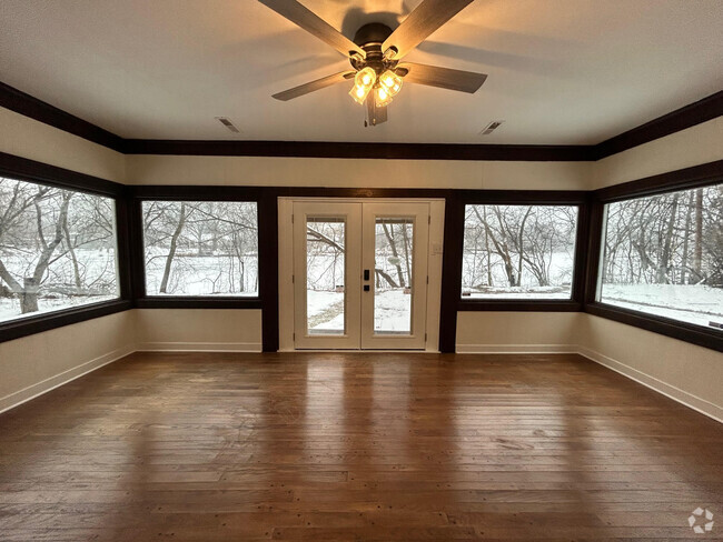 Living room with large picture windows looking to the river - 11761 N River Rd