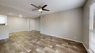 Located at 3101 Grand Pavilion Drive in Tampa, FL, this single-floor residence offers three bedrooms, two bathrooms, and a thoughtfully arranged layout. Rich wood-style flooring runs throughout the home, complemented by neutral gray walls and textured ceilings, creating a consistent and clean aesthetic across every room.

The open-concept living, dining, and kitchen area forms the heart of the home. The kitchen features white shaker cabinetry, light quartz-style countertops, a peninsula with a range hood overhead, stainless steel appliances, and a skylight that enhances natural brightness. The living and dining areas are generously proportioned, with ceiling fans and windows fitted with blinds allowing for natural light and airflow.

Each of the three bedrooms includes a ceiling fan, window with blinds, and wood-style flooring. The primary bedroom offers a comfortable footprint with direct closet access. The additional bedrooms are well-sized, with one featuring a louvered bi-fold closet. A total of three closets provides ample storage throughout.

Both bathrooms are finished with white tile tub-shower combinations, light countertops, white cabinetry, and matching wood-style flooring. A utility room and a private balcony round out the functional features of this well-appointed Tampa residence.