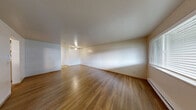 Located at 1521 N 26th St in Mount Vernon, Washington, this 2-bedroom, 1-bathroom residence offers a practical and comfortable single-floor layout. Warm hardwood-style flooring flows consistently throughout the home, lending a cohesive and inviting feel to every room.

The living room is generously sized, featuring a large window that fills the space with natural light and offers views of the surrounding greenery. Baseboard heating and a textured ceiling complete the room's functional character.

The kitchen is well-equipped with ample light wood cabinetry, a white electric range, dishwasher, full-size refrigerator, and a double-basin sink with generous counter space. The layout opens toward the living area, creating an easy connection between the two spaces.

Both bedrooms are comfortable and well-lit, each featuring sliding-door closets and windows that bring in natural light. The primary bedroom provides a solid amount of space for furnishings. One bedroom offers convenient access to an in-unit laundry area with a washer and dryer.

The bathroom is clean and functional, featuring a vanity with wood cabinetry, a mirror, toilet, and a tub/shower combination with a grab bar. Throughout the home, the neutral color palette and consistent finishes create a calm, move-in-ready atmosphere.
