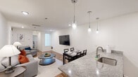 Located on Sansom Street in Philadelphia's West Philadelphia neighborhood, this 2-bedroom, 2-bathroom unit offers a thoughtfully designed single-floor layout. The open-concept kitchen and living area serves as the heart of the unit, where a granite-topped peninsula with an undermount sink and stainless steel appliances—including a full-size refrigerator, range, and built-in microwave—anchors the kitchen. Gray cabinetry provides ample storage, while pendant lighting above the peninsula adds a modern touch. The living and dining area flows seamlessly from the kitchen, featuring hardwood-style flooring, recessed lighting, and a wall-mounted flat-screen television. Natural light enters through a front-facing window, brightening the space.

Both bedrooms are carpeted with hardwood flooring and include windows that allow natural light. The primary bedroom features a large window with views of the surrounding neighborhood. Each of the two bathrooms is finished with granite vanity countertops, tile flooring, and a shower-tub combination. A connecting hallway links the living area to the bedrooms and bathrooms, maintaining an efficient and functional layout throughout the unit.