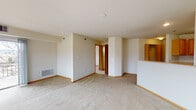 Located at 302 Prairie Heights Dr in Verona, Wisconsin, this single-floor residence offers a practical and comfortable layout designed for everyday living. The open living area is generously sized, featuring neutral-toned carpet, wood baseboards, and a half-wall peninsula that connects to the kitchen, creating an accessible, open feel throughout the main living space.

The kitchen is equipped with warm oak cabinetry, ample upper and lower storage, a stainless steel sink, and white appliances including a refrigerator, electric range, built-in microwave, and dishwasher. Stone-look tile flooring adds durability to the kitchen and extends into both bathrooms.

The bedrooms are carpeted and well-proportioned, each featuring a ceiling fan with light fixture and a window overlooking the surrounding neighborhood. Closets with bifold doors provide organized storage in the bedrooms and hallway areas. The full bathroom includes a tub-shower combination, a wood-vanity with counter space, and tile flooring. A second bathroom offers a single-sink vanity with a large mirror and grab bar. A dedicated in-unit laundry area accommodates a full-sized washer and dryer with an overhead shelf. The overall design is clean, functional, and move-in ready.