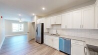 Located at 124 Center Church Rd in Sanford, NC, this well-appointed one-bedroom, two-bathroom residence offers a thoughtfully designed single-floor layout. Light-toned luxury vinyl plank flooring flows throughout the main living areas, complemented by neutral gray walls and crisp white trim that create a clean, contemporary aesthetic.

The open-concept kitchen, dining, and living area serves as the heart of the home. The kitchen is outfitted with white shaker-style cabinetry, granite countertops, a classic subway tile backsplash, and a full suite of stainless steel appliances including a refrigerator with ice maker, dishwasher, electric range, and microwave. Recessed lighting and ample cabinet storage add both function and style. A pantry provides additional storage convenience.

The living area is bright and open, with access to a private balcony through a glass-paneled door. The bedroom features plush carpet, a ceiling fan with light fixture, dual windows that invite natural light, and a spacious closet with double doors and built-in shelving. A dedicated laundry room houses a full-size washer. Both bathrooms are finished with granite vanity tops, white cabinetry, and wood-look tile flooring, with one featuring a soaking tub and shower combination. A utility room and additional storage round out this efficiently designed home.