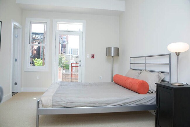 Modern downstairs bedroom with private en-suite bath, direct access to a secure gated parking area - 1123 6th St NW