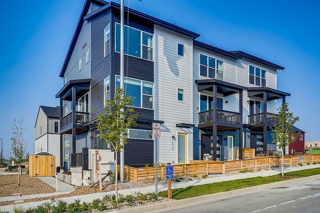Explore this contemporary townhouse, featuring expansive windows and charming balconies. - Landings at Gateway