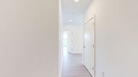 Located at 1625 Lock Ln in Madison, WI, this thoughtfully designed 2-bedroom, 2-bathroom residence offers a clean, modern aesthetic across a single floor. Light-toned wood flooring flows seamlessly throughout the entire space, creating a bright and cohesive feel. The open-concept kitchen serves as the heart of the home, featuring a large central island with a built-in sink, two-tone cabinetry pairing white upper cabinets with warm wood lower cabinets, stainless steel appliances, and modern pendant lighting — all opening to adjacent living areas. The primary bedroom is a comfortable retreat with a ceiling fan and large windows that invite natural light, while the second bedroom also offers generous proportions, a ceiling fan, and views of the surrounding neighborhood. Both bedrooms include double-door closets for ample storage. The two bathrooms are finished with warm wood vanities, light countertops, and wood-look flooring; one features a glass-enclosed walk-in shower. Additional highlights include a dedicated laundry area with cabinetry and a window overlooking lush tree canopy. The overall ambiance is bright, clean, and contemporary, with neutral tones throughout.