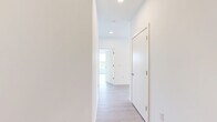 Located at 1625 Lock Ln in Madison, WI, this thoughtfully designed 2-bedroom, 2-bathroom residence offers a clean, modern aesthetic across a single floor. Light-toned wood flooring flows seamlessly throughout the entire space, creating a bright and cohesive feel. The open-concept kitchen serves as the heart of the home, featuring a large central island with a built-in sink, two-tone cabinetry pairing white upper cabinets with warm wood lower cabinets, stainless steel appliances, and modern pendant lighting — all opening to adjacent living areas. The primary bedroom is a comfortable retreat with a ceiling fan and large windows that invite natural light, while the second bedroom also offers generous proportions, a ceiling fan, and views of the surrounding neighborhood. Both bedrooms include double-door closets for ample storage. The two bathrooms are finished with warm wood vanities, light countertops, and wood-look flooring; one features a glass-enclosed walk-in shower. Additional highlights include a dedicated laundry area with cabinetry and a window overlooking lush tree canopy. The overall ambiance is bright, clean, and contemporary, with neutral tones throughout.