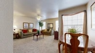 Located at 5424 Falcon Ridge Dr in Fort Worth, TX, this one-bedroom, one-bathroom unit offers a comfortable and efficiently designed single-floor layout. The living room is the heart of the space, featuring plush wall-to-wall carpeting, warm neutral-toned walls, and multiple windows that allow natural light to fill the room. A ceiling fan overhead adds both functionality and a classic touch. A dedicated dining area sits adjacent to the living room, creating a natural flow for everyday living. A mirrored pass-through shelf adds a unique architectural detail between the living area and the kitchen beyond. The bedroom is a well-proportioned retreat, complete with soft carpeting, a large sliding glass door that introduces an abundance of natural light and outdoor views, and a closet for ample storage. The bathroom is finished with warm wood-toned cabinetry, a granite-style countertop, wood-look vinyl flooring, and a tiled shower-tub combination. Throughout the unit, the consistent use of neutral tones and natural materials creates a cohesive and welcoming ambiance, making this a practical and comfortable living space in the heart of Fort Worth.