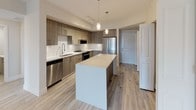 Located at 4200 NW 107 Ave in Doral, Florida, this thoughtfully designed single-floor unit offers a clean, modern aesthetic throughout. Light wood-style flooring flows seamlessly across every room, creating a bright and cohesive atmosphere complemented by crisp white walls and neutral tones.

The kitchen is a standout feature, showcasing warm wood-grain cabinetry, white quartz countertops, a geometric patterned tile backsplash, and a full suite of stainless steel appliances. A generous center island provides additional prep space and doubles as a casual dining area, while stylish pendant lighting adds a finishing touch above.

The living and dining areas offer open, airy layouts with overhead lighting and ample room for flexible furnishing arrangements. Bedrooms are well-proportioned, each benefiting from natural light through large windows with outdoor views, and are equipped with built-in closets featuring shelving and hanging storage for practical organization.

The bathrooms are finished to a high standard, with full white subway tile surrounds throughout. One bathroom features a deep soaking tub with chrome fixtures, while another includes a spacious walk-in glass-enclosed shower with recessed lighting. An in-unit laundry area adds everyday convenience, rounding out this well-appointed and move-in-ready space.