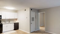 This renovated one-bedroom, one-bathroom unit at 365 Candlestick Way in Augusta, Georgia, offers a well-organized single-floor layout designed to maximize functionality. The kitchen features white shaker-style cabinetry, granite-look countertops, a tile backsplash, light wood-style flooring, and black appliances including a refrigerator, electric range, microwave, and dishwasher, creating a clean, modern aesthetic in a compact galley configuration.

The living area connects seamlessly to the kitchen and entry, continuing the light wood-style flooring and neutral wall tones. A ceiling fan overhead adds both comfort and practicality to the space. The bedroom is generously sized relative to the overall footprint, featuring plush carpeting, multiple windows with blinds that allow ample natural light and views of surrounding greenery, and a ceiling fan. A dedicated closet provides organized storage within the bedroom.

The bathroom is divided into a vanity area with a granite-topped cabinet and towel ring, and a separate water closet housing a tub-shower combination with white tile surround and a shower curtain. Neutral tones and updated fixtures throughout lend the unit a fresh, cohesive feel.