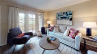 This single-floor residence offers a comfortable and functional layout designed to make the most of every room. The living area is warm and inviting, featuring wood-look flooring, neutral walls, and a sliding glass door that opens to an outdoor patio, allowing natural light to fill the space. A dedicated dining area flows naturally from the living room, creating a seamless open-concept feel.

The galley-style kitchen is efficiently designed with warm wood cabinetry, dark granite-style countertops, a stainless steel sink, and white appliances including a refrigerator and electric range. Wood-look flooring continues throughout, adding a cohesive aesthetic.

The bedroom provides a relaxing retreat with plush wall-to-wall carpet, a large window dressed with shutters and curtains that invite soft natural light, and a spacious sliding-door closet offering generous storage. A hallway connects the bedroom to the rest of the unit, providing a sense of privacy.

The bathroom features a wide vanity with dark granite-style countertops, an undermount sink, a large mirror, and wood-look flooring that complements the rest of the home. Throughout the residence, neutral tones and consistent finishes create a cohesive, move-in-ready ambiance suited for comfortable everyday living.
