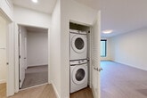 Located at 2950 Arkins Ct in Denver, CO, this well-designed one-bedroom, one-bathroom unit offers a thoughtfully utilized single-floor layout with a clean, modern aesthetic throughout. The open-concept living area features light wood-style flooring, crisp white walls, and large windows that bring in natural light, creating a bright and airy atmosphere.

The contemporary kitchen is a standout feature, equipped with light wood flat-front cabinetry, white quartz countertops, a peninsula with an undermount sink, subway tile backsplash, and a full suite of stainless steel appliances including a refrigerator, range, and microwave. Recessed lighting adds a polished finish to the space.

The living room flows seamlessly from the kitchen and offers ample room for furnishings, with light hardwood-style flooring continuing throughout. The bedroom is carpeted for comfort, includes a ceiling fan, and features access to a dedicated walk-in closet with built-in shelving — a practical and generous storage solution.

The bathroom is finished with white subway tile surrounding a full soaking tub and shower combo, complemented by wood-toned cabinetry and light flooring. A convenient in-unit stacked washer and dryer closet adds everyday functionality. The unit combines modern finishes with efficient design in a well-located Denver address.