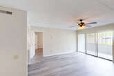 Located at 730 Germantown Cir in East Ridge, Tennessee, this well-appointed one-bedroom, one-bathroom residence offers a comfortable and functional layout across a single floor. Light hardwood-style flooring flows consistently throughout the unit, creating a cohesive and clean aesthetic in every room.

The open living area is bright and welcoming, featuring a ceiling fan with integrated lighting and large sliding glass doors fitted with vertical blinds that allow abundant natural light while providing views of the outdoors. The textured ceiling adds a classic touch throughout the space.

The kitchen is efficiently designed with gray cabinetry, stone-toned countertops, and a full suite of black appliances including a refrigerator, electric range, dishwasher, and built-in range hood. A pass-through opening connects the kitchen to the living area, enhancing the open feel.

The generously sized primary bedroom includes a ceiling fan, a window with natural light, and ample wall space. The bathroom features a single-sink vanity with stone-toned countertop and a separate tub-shower combination.

A dedicated closet area includes a stacked washer and dryer unit alongside open wire shelving, providing convenient in-unit laundry and organized storage. This thoughtfully laid-out residence offers practical comfort in a clean, move-in-ready setting.