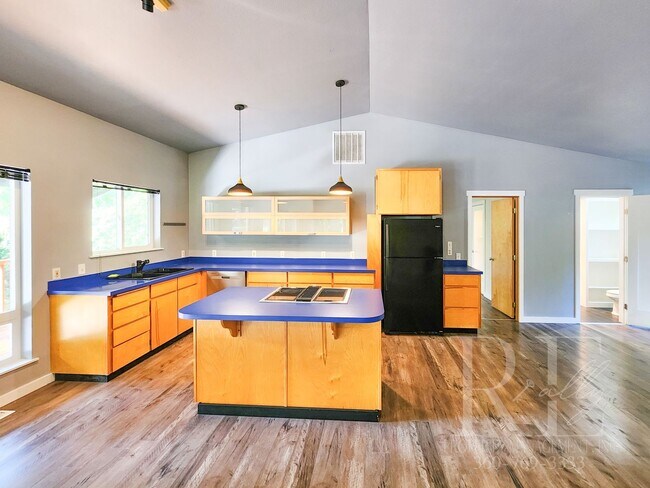 Building Photo - Vaulted Ceilings, Unique Designer Kitchen & Expansive Half-Acre Setting with Flexible Living Spaces