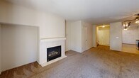 This two-story home in Fresno, CA offers a practical and comfortable layout across two floors. The main level features a carpeted living room anchored by a tiled fireplace with a classic white mantel, creating a warm focal point. The kitchen is well-appointed with warm oak cabinetry, white countertops, a sink, and tile flooring, with corner windows that bring in natural light. A convenient hallway bathroom with a vanity and tile flooring is also located on this floor, along with a staircase leading to the upper level.

Upstairs, three carpeted bedrooms provide restful retreats. The generously sized primary bedroom offers ample space, while the additional bedrooms are well-proportioned, each featuring ceiling fans and natural light from windows. Two closets serve the upper level, and a full bathroom with a shower-tub combination, oak vanity, and tile flooring completes the floor.

The attached garage features a concrete floor and an automatic opener, offering secure parking and additional storage. Throughout the home, neutral wall tones and carpet create a clean, cohesive aesthetic. Hallways connect each area efficiently, supporting a functional flow across both levels of this well-structured Fresno residence.