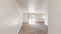 Located at 700 Kincheloe Ct in Woodland, California, this two-bedroom, one-bathroom residence offers a practical and comfortable single-floor layout. The open kitchen is well-equipped with light wood cabinetry, ample counter space with a neutral laminate finish, a double-basin sink, and white appliances including a gas range, dishwasher, and refrigerator. Wood-look flooring runs throughout the kitchen and dining area, which benefits from a window that allows natural light to fill the space. The living area is carpeted and provides a welcoming entry point with a hallway connecting the main rooms. Both bedrooms feature plush carpet flooring, neutral-toned walls, and sliding mirrored closet doors offering generous storage. Windows in each bedroom frame views of the surrounding neighborhood and greenery, keeping the rooms bright and airy. The bathroom is finished with wood-look flooring, a vanity with under-sink cabinetry, a mirror, and towel bars, providing a clean and functional design. A connecting hallway ties all rooms together efficiently. The overall aesthetic is clean, neutral, and move-in ready, making it a straightforward and functional living space in Woodland, CA.