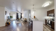 Located in Austin, TX, this single-story 2-bedroom, 3-bathroom residence offers a thoughtfully designed open-concept floor plan that maximizes both function and comfort. Rich hardwood-style flooring flows throughout the main living areas, complemented by crown molding and crisp white walls that create a clean, modern aesthetic.

The living room is bright and inviting, featuring a ceiling fan, large windows with elegant draping, and direct access to an outdoor area. It connects seamlessly to a dedicated dining space, highlighted by a stylish track light fixture and arched entryway leading into the hallway.

The kitchen is well-equipped with dark espresso cabinetry, granite countertops, stainless steel appliances, and a peninsula with bar seating and a double sink — ideal for both cooking and casual dining.

The spacious primary bedroom offers ceiling fan, multiple windows for natural light, and hardwood-style flooring, while the bathrooms include a soaking tub with tile surround. Two generously sized walk-in closets with built-in shelving provide ample storage. A dedicated laundry room accommodates a full-size washer and dryer side-by-side.

The overall ambiance is modern and comfortable, making this an exceptionally livable Austin home.