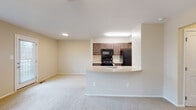Located at 3343 Winterbourne Rd in Baltimore, MD, this single-floor unit offers a practical and well-organized layout designed for comfortable everyday living. The open-concept living and kitchen area serves as the central hub of the space, where a curved peninsula counter with an integrated sink creates a natural division between the two zones while maintaining an open, connected feel. The kitchen is equipped with dark espresso-toned cabinetry, black appliances including a refrigerator, range, and microwave, and light-colored countertops. Light hardwood-style flooring runs through the kitchen, while neutral wall-to-wall carpet extends throughout the living area and bedrooms, contributing to a cohesive, understated aesthetic. Recessed lighting and under-cabinet fixtures ensure the kitchen and living areas are well-lit. The bedrooms are generously proportioned, each featuring ceiling fans with light fixtures, plush carpet, closet access, and windows that allow natural light to filter in. The bathroom is cleanly finished with tile flooring, a full tub-shower combination with white tile surround, and a vanity with dark cabinetry. The living area also benefits from multiple windows and access to an exterior door, enhancing the sense of openness throughout.