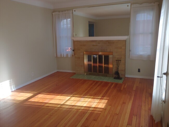 Living room with fireplace, viewed from the front door. - 7415 1st Ave S