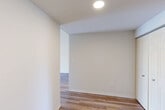 Located at 50 Park Row W in the heart of Providence, Rhode Island, this well-designed two-bedroom, two-bathroom residence offers a thoughtfully organized single-floor layout. Light-toned hardwood-style flooring runs throughout, lending warmth and visual continuity across every room.

The combined dining and living area serves as the central gathering space, anchored by large floor-to-ceiling windows that flood the room with natural light and frame impressive views of the Providence cityscape, including a prominent view of the Rhode Island State House. Crown molding adds a refined architectural detail to this open space.

The kitchen is equipped with crisp white cabinetry, stainless steel appliances including a refrigerator and dishwasher, a sleek subway tile backsplash in a cool slate tone, and ample counter and storage space — a clean, modern aesthetic throughout.

The spacious primary bedroom features a wide closet and a large window with city views, while the second bedroom is also generously sized with its own closet. Three closets in total provide excellent storage throughout the residence. Both bathrooms are finished with contemporary vanities, framed mirrors, and clean neutral tones. An in-unit laundry area and a connecting hallway complete the functional and efficient floor plan.