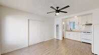 Located at 818 S Mariposa Ave in the Koreatown neighborhood of Los Angeles, this studio unit offers a thoughtfully arranged single-floor layout. The open living area is bright and clean, featuring light wood-style flooring that runs throughout the space, crisp white walls, and a textured ceiling fitted with a modern ceiling fan with integrated lighting. Natural light enters through a front-facing window, enhancing the airy, open feel of the room. A sliding-door closet is built into the living area, providing convenient storage without encroaching on the usable floor space.

The kitchen area connects seamlessly to the main living space and is outfitted with white cabinetry, a subway tile backsplash, a countertop sink, and includes a refrigerator and gas range. The layout makes efficient use of the available space while maintaining a clean, functional design.

The bathroom is a full unit featuring a vanity with under-sink storage, a medicine cabinet with mirror, a window for natural ventilation, and matching light wood-style flooring that ties in with the rest of the unit. The overall aesthetic is consistent and clean throughout — a neutral, white-toned palette that provides a versatile canvas for personalization.