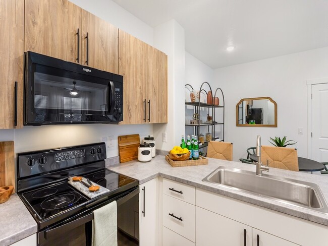 Kitchen with Black Appliances - The Veridian Apartments & Townhomes