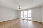 Located at 318 W Wilson Ave in Glendale, California, this contemporary single-floor residence offers a clean, modern aesthetic throughout. Light wood-style flooring flows seamlessly across the entire unit, creating a cohesive and airy feel.

The kitchen is a standout feature, outfitted with a full suite of stainless steel appliances including a gas range, built-in microwave, dishwasher, and refrigerator. White upper cabinetry is complemented by warm wood-toned lower cabinets and bright white countertops, with a subtle tile backsplash completing the polished look. Track lighting in the entry corridor adds a modern touch.

A hallway area conveniently houses a stacked in-unit washer and dryer alongside additional storage, streamlining everyday living. The living area benefits from generous natural light, with large floor-to-ceiling windows offering views of the surrounding Glendale neighborhood.

The bedroom is bright and open, featuring expansive windows that flood the space with sunlight and provide urban views. The bathroom is well-appointed with a wood-toned vanity, white countertop, built-in wall shelving, a soaking tub with shower, and light tile flooring that echoes the unit's contemporary design language. Overall, the space presents a clean, modern living environment in a prime Glendale location.