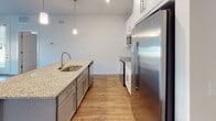 Located at 22 Evesboro-Medford Rd in Medford, NJ, this single-floor unit offers a clean, modern design throughout. The open-concept layout connects the living area to a well-equipped kitchen, which serves as the heart of the space. The kitchen features a central island with granite countertops, an undermount sink, and pendant lighting overhead. Gray lower cabinetry pairs with white upper cabinets, while stainless steel appliances—including a refrigerator, range, and microwave—complete the functional setup. Rich hardwood-style flooring extends throughout the living and kitchen areas, adding warmth and continuity.

The living space is generously proportioned, with neutral walls, a ceiling fan, and natural light filtering in through windows. Bedrooms are finished with plush carpeting, ceiling fans, and ample natural light from well-placed windows. At least one bedroom includes access to a walk-in closet, offering practical storage. The bathroom is elegantly finished with large-format tile flooring, a white vanity with granite countertops, a framed mirror, and a tub-shower combination surrounded by classic subway tile. The overall ambiance is bright, clean, and move-in ready.