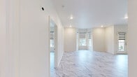 Located in the Chenal Valley neighborhood of Little Rock, Arkansas, this thoughtfully designed 2-bedroom, 2-bathroom single-floor residence offers a clean, modern aesthetic throughout. Marble-look luxury flooring flows seamlessly from room to room, lending an air of elegance and continuity to the entire space.

The open-concept kitchen and living area serves as the heart of the home. The kitchen features dark cabinetry with sleek hardware, striking marble-look countertops, a large center island with pendant lighting, and a full suite of stainless steel appliances including a refrigerator, dishwasher, and range. The living room is bright and airy, with recessed lighting and dual-pane windows fitted with modern zebra-style roller shades that allow for versatile light control.

The spacious primary bedroom includes a ceiling fan, generous proportions, and access to a well-organized walk-in closet outfitted with wire shelving and basket storage. The bathrooms continue the marble-look flooring and feature dark vanities with stone-look countertops and tiled walk-in showers.

A dedicated laundry room provides added convenience with upper dark cabinetry for storage and washer/dryer hookups. The second bedroom also features a ceiling fan and a closet. Throughout the residence, crisp white walls, recessed lighting, and consistent finishes create a polished, cohesive living environment.