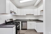 Step into a world of contemporary living and effortless style at 1830 Brea Blvd, Fullerton. This stunning 690 square foot home is a testament to modern design and smart living. As you enter, you're greeted by soaring vaulted ceilings that create an airy, expansive feel throughout the space.

The heart of this home is the beautifully appointed kitchen, featuring gleaming stainless steel appliances, crisp white cabinetry, and a spacious island perfect for casual dining or entertaining. The open concept layout seamlessly connects the kitchen to the living areas, ideal for those who love to host or simply enjoy an uncluttered, flowing space.

The generously sized bedroom, measuring 170 square feet, offers a tranquil retreat with ample natural light and room for relaxation. With two well-designed bathrooms, this home provides convenience and luxury in equal measure. The bathrooms boast modern fixtures, elegant vanities, and a clean, contemporary aesthetic.

Throughout the home, you'll find high-quality vinyl plank flooring that combines the warmth of wood with easy maintenance. The neutral color palette serves as a blank canvas, allowing you to express your personal style.

Energy efficiency is at the forefront with modern climate control systems, ensuring year-round comfort. Two closets provide ample storage space, keeping your home organized and clutter-free.

Located in the vibrant city of Fullerton, this home offers the perfect balance of urban convenience and suburban charm. Whether you're a first-time homebuyer, downsizing, or seeking an investment property, this beautifully designed space is ready to become your new home sweet home.