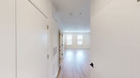 Located at 725–735 Coleman Blvd in Mount Pleasant, South Carolina, this efficiently designed unit offers a cohesive, modern living experience across a single floor. Light-toned hardwood-style flooring runs throughout the space, creating a consistent and clean aesthetic.

The kitchen is a standout feature, showcasing a two-tone cabinet design with crisp white upper cabinetry and slate gray lower cabinets, complemented by a classic white subway tile backsplash and light countertops. A full suite of stainless steel appliances — including a French door refrigerator with ice maker, dishwasher, electric range, and over-the-range microwave — equips the kitchen for everyday use. A single-basin sink with a matte black faucet adds a contemporary touch.

The open living area is bright and airy, finished with clean white walls and a ceiling fan with integrated lighting. Natural light enters through windows fitted with white blinds, offering views of surrounding greenery.

The bathroom continues the modern design language with white shaker-style cabinetry, a white countertop vanity, matte black hardware, a round mirror, and a full soaking tub with shower combination. The space also includes a dedicated closet, providing practical storage. Overall, the unit presents a clean, modern, and functional living environment.