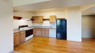 Located at 875 Cinnabar St in San Jose, California, this two-bedroom, one-bathroom residence offers a practical and well-organized single-floor layout. The kitchen is a functional highlight, featuring warm wood cabinetry, granite-style countertops, hardwood flooring, and a full suite of appliances including an electric range, dishwasher, and refrigerator. Ample cabinet storage and counter space make it ideal for everyday cooking. The open transition from the kitchen toward the living area creates a connected, easy-flowing layout.

The living room is generously sized with plush carpeting and neutral wall tones, creating a comfortable and adaptable living space. Both bedrooms are carpeted and filled with natural light from large windows with blinds. The primary bedroom benefits from added space and features sliding glass doors that open directly onto a private balcony, offering an outdoor retreat. The second bedroom also receives good natural light and provides practical closet storage.

The bathroom is clean and well-appointed, with wood-tone cabinetry, a granite-style vanity countertop, a large mirror, hardwood flooring, and a full soaking tub with a shower. Additional features include multiple closets throughout, dedicated laundry facilities, and a second kitchen area. The overall aesthetic is bright, neutral, and move-in ready.