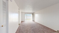 Located at 2075 N Highland Ave in Clearwater, Florida, this single-floor, one-bedroom, one-bathroom unit offers a functional and well-organized layout. The combined living and dining area serves as the heart of the home, featuring neutral carpet flooring, bright white walls, and a textured ceiling. A large sliding glass door floods the space with natural light and provides direct views of the outdoors, while a pendant light fixture illuminates the dining area near the front entrance. The kitchen is thoughtfully designed with white cabinetry, granite-style countertops, light wood-look flooring, and a full suite of appliances including an electric range with overhead ventilation. Ample counter and cabinet space makes it highly practical. The generously sized bedroom features plush carpet, a wide window with natural light, and a full-width louvered closet, with additional closets found throughout the unit for exceptional storage. The bathroom is clean and bright, outfitted with light wood-look tile flooring, a granite-top vanity, and a full-size tub and shower combination. A dedicated utility room and hallway round out the layout, contributing to an efficient, move-in-ready living space in the heart of Clearwater.