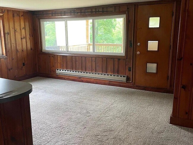 Living room with entrance to private, lower-level deck. - 149 Limerock Ter
