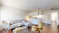 Located on Hazeltine Avenue in the heart of Sherman Oaks, Los Angeles, this well-appointed one-bedroom, one-bathroom unit offers a functional and comfortable single-floor layout. The living room is bright and welcoming, filled with natural light streaming through large windows that frame views of the tree-lined street. Rich hardwood-style flooring runs throughout the main living areas, complementing the clean, neutral palette of the walls and textured ceiling. A wall-mounted HVAC unit provides climate control directly in the living space. The open-concept design connects the living and dining areas seamlessly, with the kitchen accessible via a pass-through counter featuring granite-style countertops. The kitchen is equipped with white cabinetry, a gas range, refrigerator, and under-cabinet lighting, offering efficient use of space. The generously sized bedroom is carpeted for comfort and features a sliding glass door that opens to an outdoor view of lush greenery, filling the room with natural light. A mirrored sliding closet adds both storage and a sense of depth to the bedroom. Three closets in total provide ample storage throughout the unit. The bathroom is conveniently positioned adjacent to the bedroom. The surrounding neighborhood features well-maintained sidewalks and green lawns, situated in a vibrant Los Angeles community.