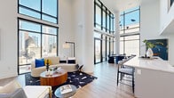 Located in the heart of Houston at 808 Crawford St, this sophisticated two-story residence offers an exceptional blend of modern design and urban living. The main floor commands attention with soaring double-height ceilings and a dramatic floor-to-ceiling glass curtain wall that frames sweeping views of the downtown Houston skyline, flooding the open-plan living and dining areas with abundant natural light. Light hardwood flooring flows throughout, complementing the clean, contemporary aesthetic. A sleek kitchen with a generous island anchors the main living space, while a striking staircase with warm wood handrails and black metal balusters connects both floors. The upper level features three well-appointed bedrooms, including a spacious primary suite with a large walk-in closet outfitted with built-in shelving and hanging rails. Six bathrooms are finished to a high standard—some featuring large-format neutral tile, soaking tubs, and glass-enclosed walk-in showers with freestanding tubs. Three dedicated closets provide ample storage, while a dedicated laundry room with full-size washer and dryer adds everyday convenience. Upper-floor hallways offer additional skyline views through modern windows, reinforcing the residence's strong connection to its vibrant urban surroundings.