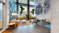 Located at 811 S Washington Ave in Minneapolis, this stylish leasing lobby makes a striking first impression with its double-height ceilings and expansive floor-to-ceiling windows that flood the space with natural light and offer views of the surrounding urban streetscape. The open-plan layout seamlessly blends distinct functional zones across a generously sized single floor.

The lounge area is anchored by a comfortable tan sofa, mid-century modern accent chairs, and a clean-lined coffee table arranged atop a neutral area rug — all set against large pane windows framed by tall indoor fiddle-leaf fig trees. A dramatic large-scale mural depicting a locomotive commands one wall, lending an industrial-artistic character to the welcoming environment.

The hallway corridor transitions smoothly from large-format tile flooring near the entrance to warm hardwood, guiding visitors toward the elevator bank. Exposed concrete columns provide structural punctuation throughout, complementing the contemporary design palette of gray, white, and warm wood tones. Recessed and track lighting, along with pendant fixtures, ensure well-distributed illumination throughout.

The elevator lobby features stainless steel elevator doors, rich hardwood flooring, exposed wooden ceiling beams, and curated wall art, adding warmth and sophistication. Additional seating vignettes with leather chairs and tufted ottomans complete the space, creating an inviting, community-oriented atmosphere.