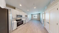 Located at 1639 E Tropicana Ave in Las Vegas, NV, this two-bedroom, two-bathroom residence offers a thoughtfully designed single-level layout. Light wood-style flooring runs throughout, creating a cohesive and contemporary feel across all rooms.

The kitchen is a standout feature, outfitted with white shaker cabinetry extending to the ceiling, light gray subway tile backsplash, white quartz countertops, and a full suite of stainless steel appliances including a side-by-side refrigerator with ice and water dispenser, electric range, built-in microwave, and dishwasher. The kitchen flows naturally into the open living area, which is brightened by a large window that invites natural light.

Both bedrooms are comfortably sized, with the primary bedroom offering a ceiling fan and a window with outdoor views. The unit includes three closets, providing generous storage throughout, including a dedicated walk-in closet accessible from one of the bathrooms. Each bathroom features a tub/shower combination with clean white tile surround, a vanity with undermount sink, and wood-style flooring. Recessed lighting and neutral warm-toned walls complete the clean, move-in-ready aesthetic of this Las Vegas residence.