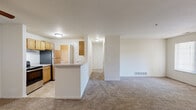 Located at 101 Lake Village Boulevard in Dearborn, MI, this well-appointed one-bedroom, one-bathroom residence offers a thoughtfully designed single-floor layout. The open-concept living and dining area is generously sized, featuring neutral-toned carpet, crisp white walls, and multiple windows that invite natural light throughout the space. A peninsula counter seamlessly connects the kitchen to the main living area, making it ideal for both daily living and entertaining.

The galley-style kitchen is efficiently designed with warm honey-toned cabinetry lining both walls, light countertops, tile flooring, and a full suite of appliances including a stainless steel refrigerator, electric range, and dishwasher. A pass-through leads directly to the in-unit laundry area, which includes a washer and overhead shelving for added convenience.

The carpeted bedroom offers a comfortable retreat with a closet and a window providing natural light. The full bathroom features tile flooring, a warm wood-toned vanity with a wide mirror, overhead lighting, and a tub-shower combination. Four closets throughout the unit provide exceptional storage capacity, rounding out this practical and comfortable Dearborn residence.