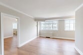 Located at 5323 Connecticut Ave NW in Washington, DC's Chevy Chase neighborhood, this one-bedroom, one-bathroom unit offers a thoughtfully designed layout across a single floor. The living area is bright and open, featuring warm hardwood flooring, elegant crown molding, and large windows that allow abundant natural light and views of the surrounding cityscape. The neutral, soft-toned walls create a clean and inviting atmosphere throughout.

The spacious primary bedroom includes a ceiling fan, hardwood floors, and generous closet space, with a secondary windowed nook ideal for a reading corner or home office. Two closets provide ample storage throughout the unit.

The kitchen is efficiently appointed with stainless steel appliances — including a gas range, microwave, and refrigerator — complemented by granite countertops, white cabinetry, a classic subway tile backsplash, and sleek marble-look tile flooring.

The bathroom is finished with refined marble-patterned tile on both the floors and walls, brass hardware accents, a modern vanity, and a full shower, lending the space a polished, contemporary feel. Overall, the unit presents a well-maintained, move-in-ready residence with classic architectural details and modern finishes.