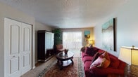 Located at 1645 SW 37th Terrace in Topeka, Kansas, this single-story residence offers a practical and comfortable layout across several well-defined living spaces. The living room serves as the heart of the home, featuring wall-to-wall carpet, a large sliding glass door fitted with vertical blinds that allows natural light to fill the space, and a double-door closet providing convenient storage. The room connects seamlessly to the rest of the home.

The kitchen is designed for functionality, featuring dark cabinetry with sleek hardware, granite-style countertops, tile flooring, and a full suite of appliances including an electric range, dishwasher, and refrigerator. Adjacent to the kitchen, the dining area accommodates a full-sized table and benefits from a ceiling fan overhead.

The home includes two bedrooms, each finished with carpet flooring and windows with blinds that bring in natural light. Both rooms offer a calm, comfortable atmosphere with adequate space for furnishings.

A bathroom is accessible from the main living area. Throughout the home, textured ceilings are a consistent architectural detail, and neutral wall tones create a cohesive, understated aesthetic across all rooms.