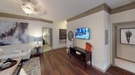 Located at Madison Square Place in Charlotte, NC, this single-story residence offers a cohesive and carefully designed interior. The living room serves as the heart of the home, featuring rich hardwood flooring, crown molding, and multiple windows dressed with sheer curtains and wood blinds that invite abundant natural light. A pendant light fixture anchors the space, which flows seamlessly into a separate dining area highlighted by a elegant chandelier, a glazed door providing outdoor access, and additional windows framing exterior views.

The kitchen is appointed with dark cabinetry, granite countertops, a classic subway tile backsplash, stainless steel appliances, and track lighting overhead — combining both style and function in an efficient galley-style layout.

Multiple bedrooms offer a tranquil retreat, each carpeted and equipped with ceiling fans, generous windows, and ample natural light. The primary bedroom connects to a spacious walk-in closet outfitted with wire shelving and hanging rods. The bathroom features large-format tile surrounding a tub-shower combination, complemented by neutral tones throughout. Consistent warm, neutral finishes and thoughtful details unify the entire residence.