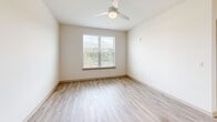 Located at 2250 Oak Road Southwest in Snellville, GA, this well-appointed 2-bedroom, 2-bathroom single-floor residence offers a thoughtfully designed open-concept layout. The kitchen is a standout feature, showcasing white shaker cabinetry, granite countertops, a large center island with a black matte sink, stainless steel appliances, and a modern industrial-style pendant light fixture — all flowing seamlessly into the living area, which is accented by recessed lighting and a ceiling fan.

Light wood-tone luxury vinyl plank flooring runs throughout the main living areas, lending a clean, contemporary aesthetic, while plush carpet adds warmth to the bedrooms. Both bedrooms are bright and inviting, each featuring a ceiling fan and a window with outdoor views of surrounding greenery.

Each bathroom is finished with gray vanity cabinetry, white quartz countertops, and black hardware accents. One bathroom features a glass-enclosed shower, while the other includes a dedicated walk-in closet with built-in wire shelving systems — ideal for maximizing storage. A second spacious walk-in closet further enhances the storage options throughout the home. The overall ambiance is bright, modern, and move-in ready.