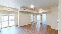 Located at 2525 N Hill Field Rd in Layton, Utah, this thoughtfully designed two-bedroom, one-bathroom unit offers a clean, modern aesthetic throughout its single-floor layout. The kitchen is a standout feature, equipped with stainless steel appliances including a refrigerator, electric range, and built-in microwave, all complemented by light wood cabinetry with matte black hardware and a sleek countertop with an undermount sink. Wood-style plank flooring runs through the kitchen and living areas, adding warmth and continuity. The open living area connects seamlessly to a private balcony via sliding glass doors, filling the space with natural light. Both bedrooms are carpeted and feature neutral tones, with windows that bring in additional daylight. The primary bedroom is a comfortable size and is served by a dedicated walk-in closet with dual hanging rods and shelving. The bathroom is finished with a light wood vanity, stone-style countertop, undermount sink, matte black fixtures, and contemporary vanity lighting above a large mirror. The overall design balances functionality with modern style, creating a bright, cohesive living environment well-suited for everyday comfort.